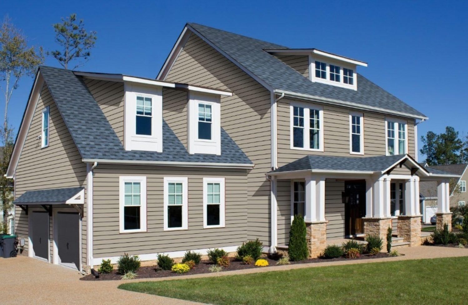 Home exterior with natural clay-coloured siding | Nansemond River Roofing & Siding