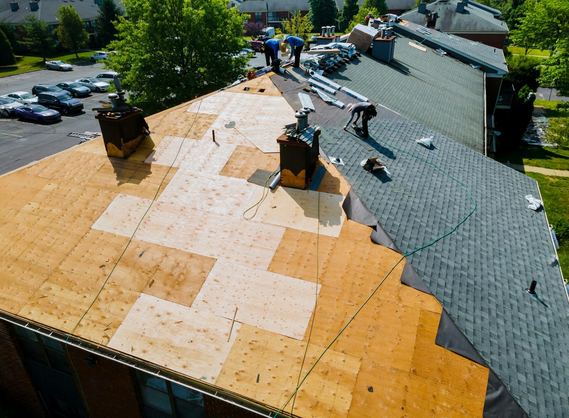 Old roof replacement with new shingles on an apartment building | Nansemond River Roofing & Siding