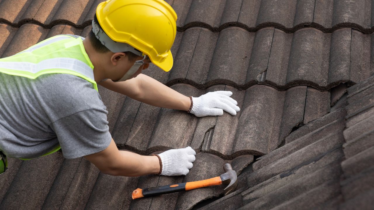 Roofing contractor at work on a house | Nansemond River Roofing & Siding